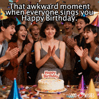 Birthday girl frozen with nervous smile as friends sing around her gif