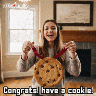 Friend placing a cookie medal proudly around someone’s neck for a funny congratulations gif